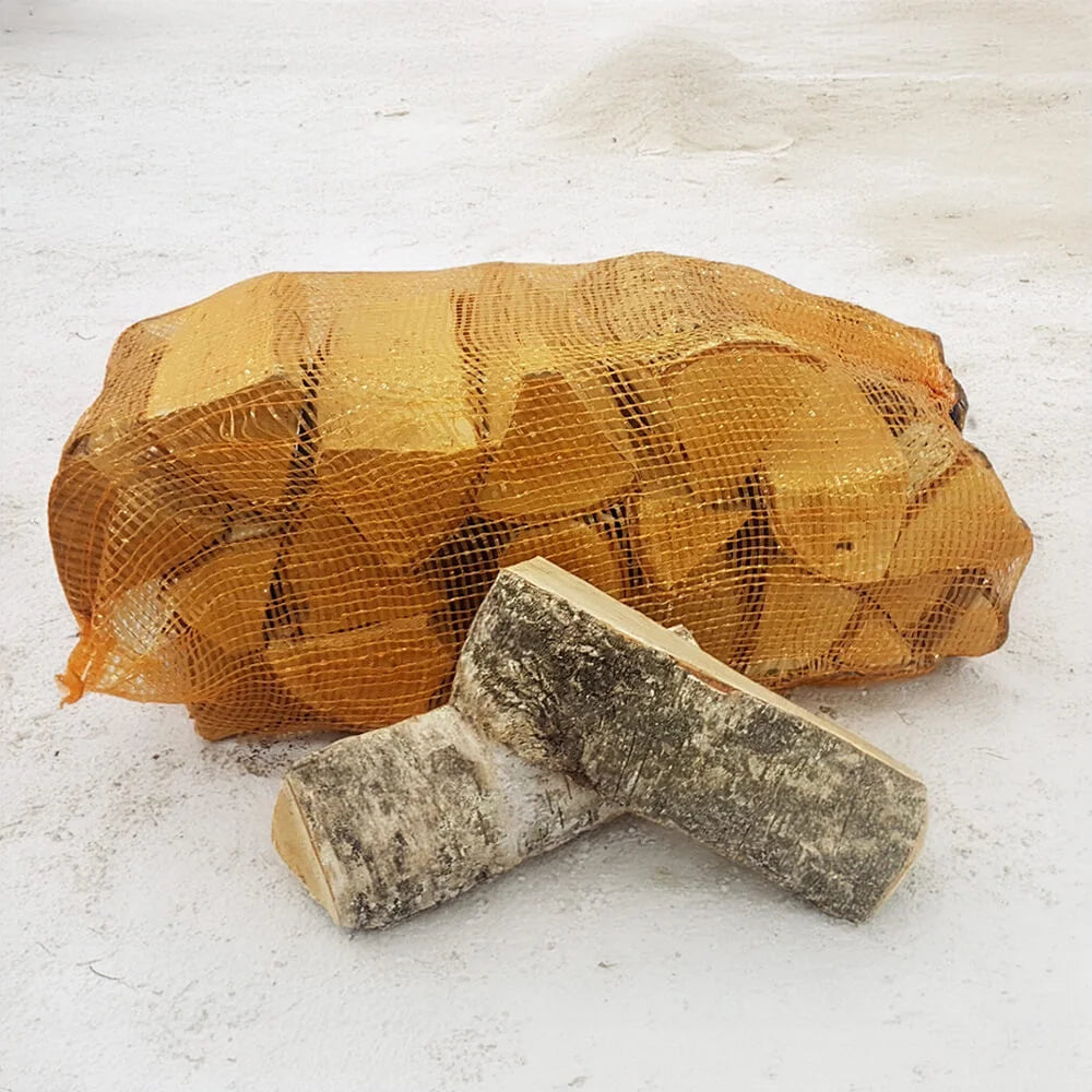 Bag of firewood and two logs on a snowy ground