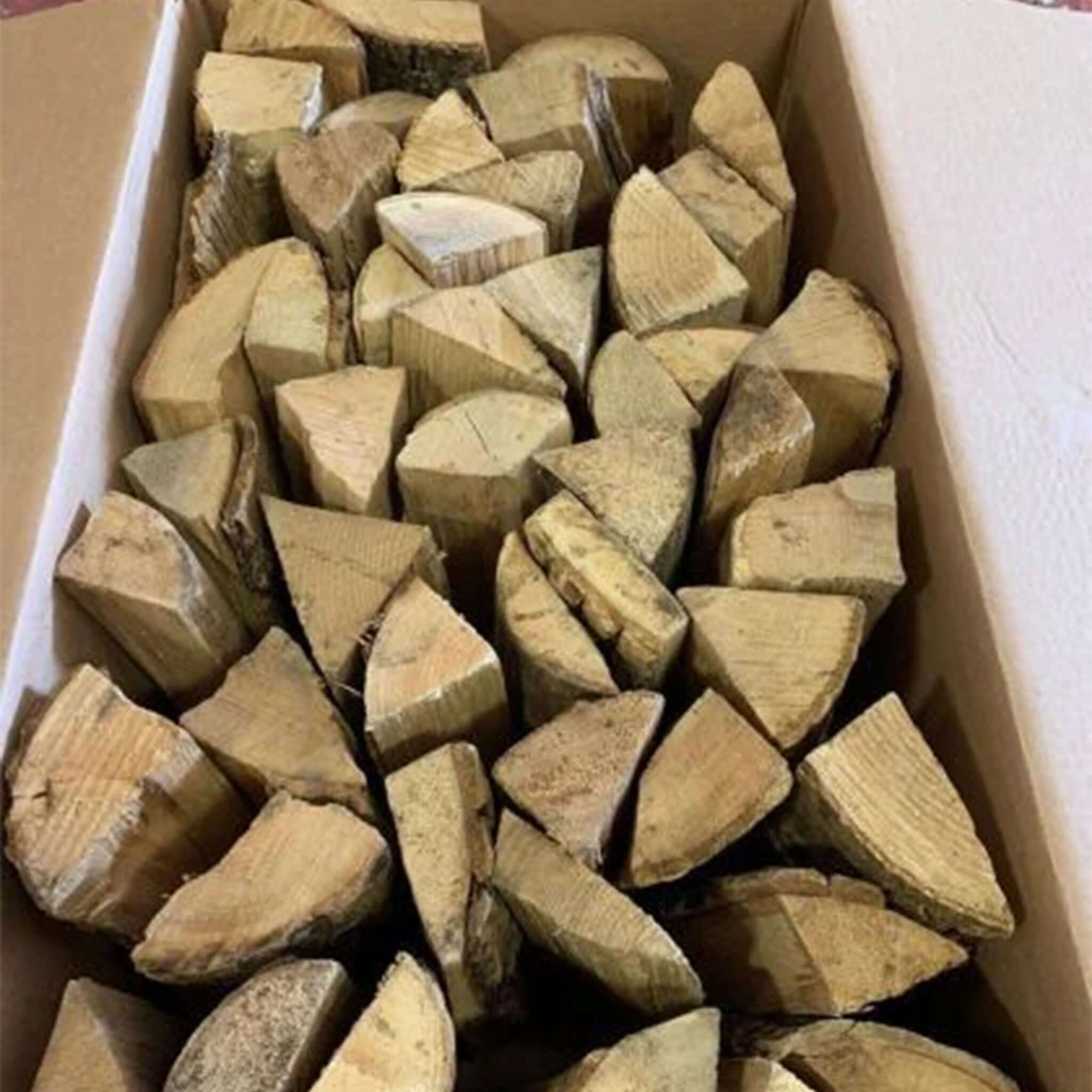 Box filled with triangular wooden blocks on a white surface