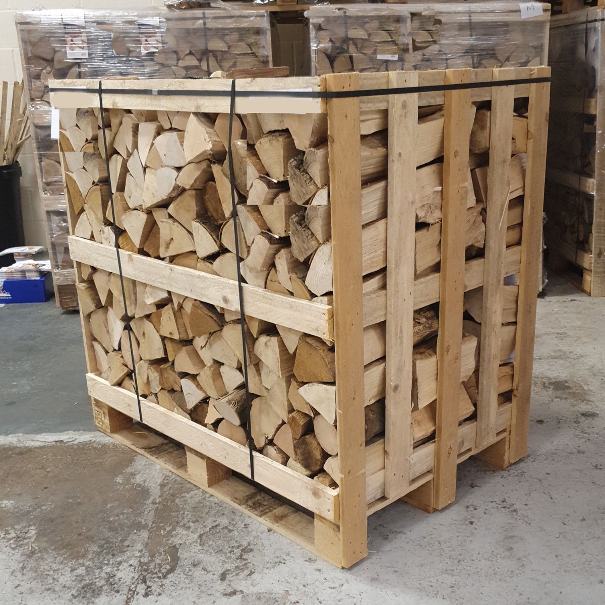 Stack of chopped wood on a wooden pallet in an indoor setting