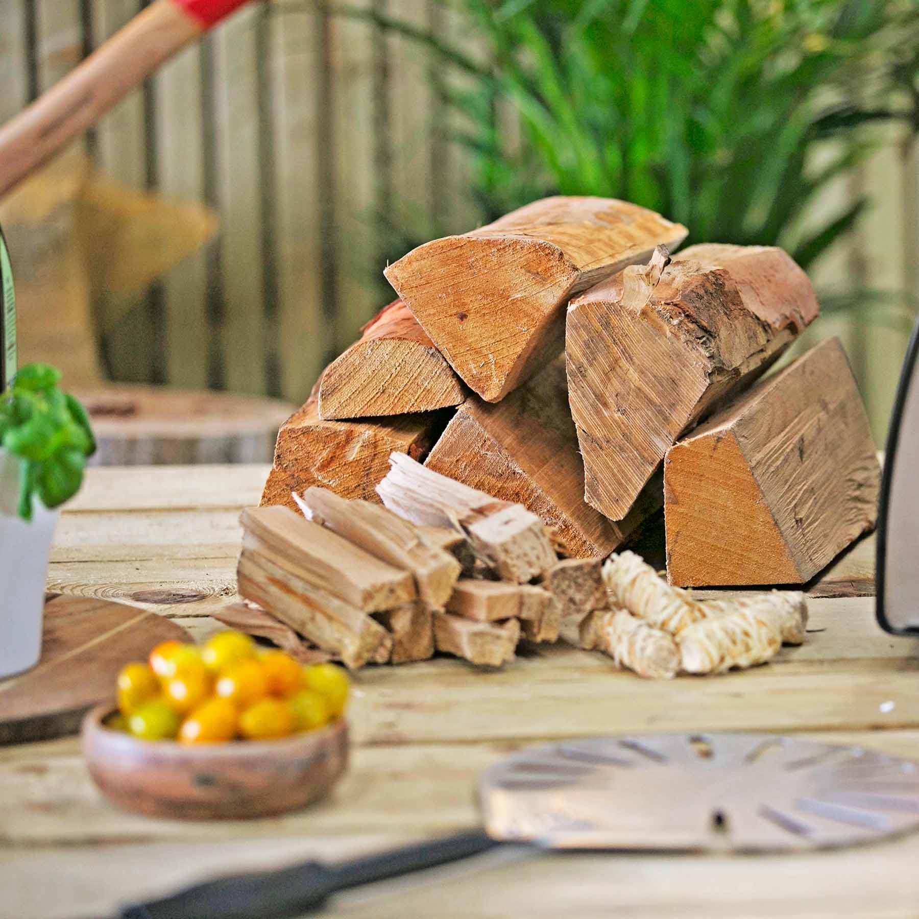 Stack of firewood on a wooden surface with a blurred background