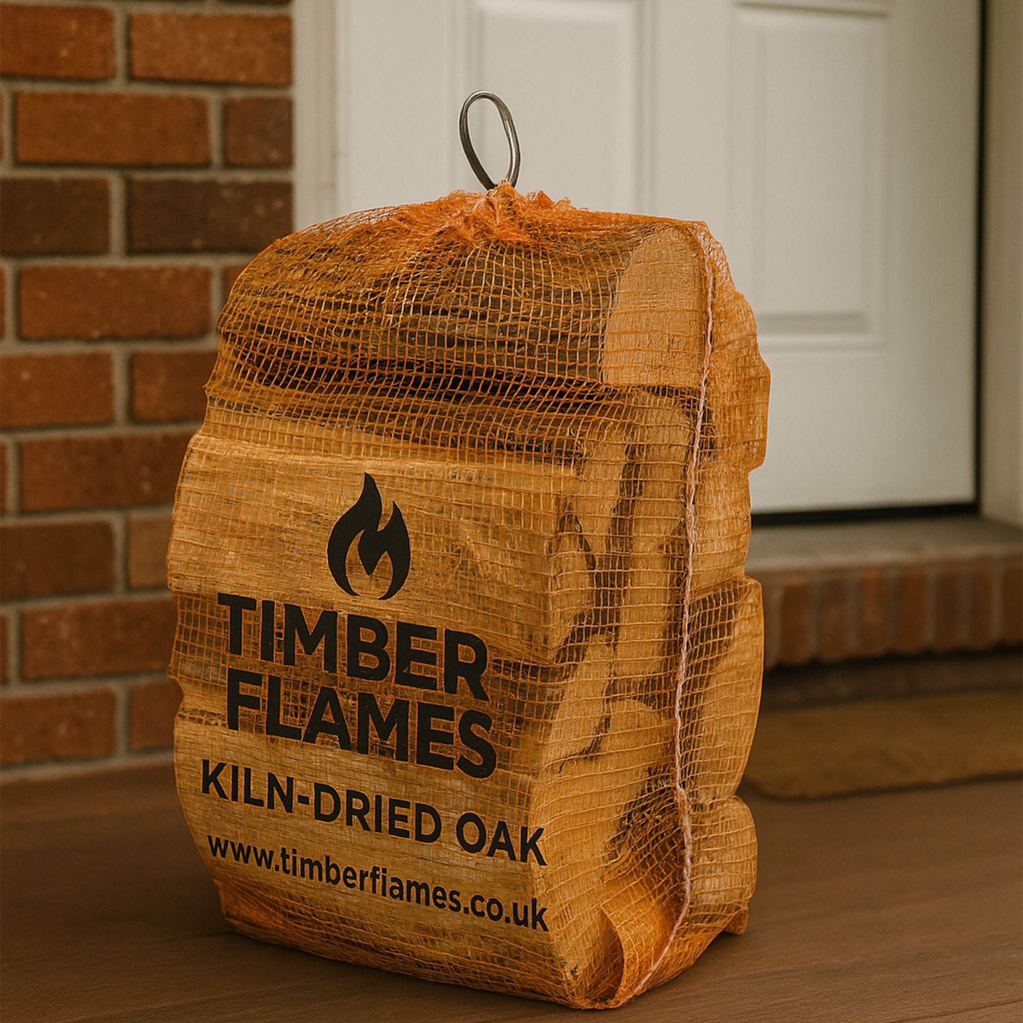 Bag of Timber Flames kiln-dried oak firewood against a brick wall.