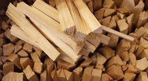 Stack of wooden firewood with a small axe on top