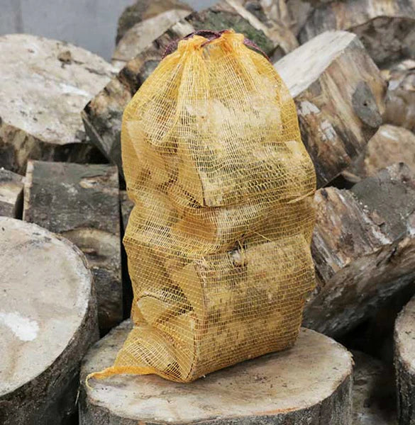 Yellow mesh bag on a stack of firewood